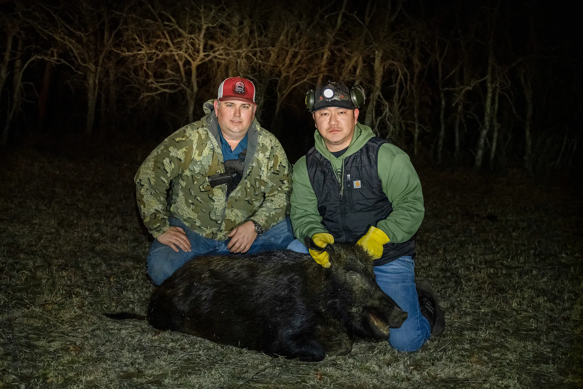 Hunters with a hog taken at night